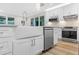 Modern farmhouse kitchen with white cabinets, farm sink, and stainless steel appliances at 806 Palmer St, Orlando, FL 32801