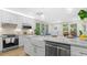 Modern kitchen with farmhouse sink, white cabinets, and marble countertops at 806 Palmer St, Orlando, FL 32801