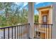 Private balcony overlooking a tree-lined street at 8749 Via Tavoleria Way, Windermere, FL 34786