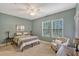 Spacious bedroom with two windows and a ceiling fan at 8749 Via Tavoleria Way, Windermere, FL 34786