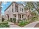 Two-story townhome with front walkway, landscaping, and a balcony at 8749 Via Tavoleria Way, Windermere, FL 34786