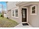 Townhome entrance with dark brown door and a walkway at 8749 Via Tavoleria Way, Windermere, FL 34786