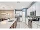 Modern kitchen with white cabinets, stainless steel appliances, and quartz countertops at 8749 Via Tavoleria Way, Windermere, FL 34786