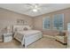 Spacious main bedroom with large bed, nightstands and a seating area at 8749 Via Tavoleria Way, Windermere, FL 34786