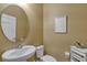 Powder room with pedestal sink, toilet, and oval mirror at 8749 Via Tavoleria Way, Windermere, FL 34786