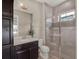 Bathroom with walk-in shower and dark vanity at 8758 Pinter St, Orlando, FL 32827