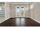 Bright bedroom with hardwood floors and private balcony access at 8758 Pinter St, Orlando, FL 32827