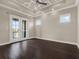 Main bedroom with dark hardwood floors and access to a private balcony at 8758 Pinter St, Orlando, FL 32827