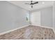 Spacious bedroom with hardwood floors and double doors at 8758 Pinter St, Orlando, FL 32827