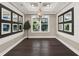 Formal dining room with dark hardwood floors, chandelier, and decorative mirrors at 8758 Pinter St, Orlando, FL 32827