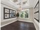 Formal dining room with dark hardwood floors, chandelier, and decorative mirrors at 8758 Pinter St, Orlando, FL 32827