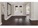 Spacious entryway with dark hardwood floors and double doors leading to the backyard at 8758 Pinter St, Orlando, FL 32827