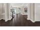 Elegant interior hallway with dark hardwood floors and white columns at 8758 Pinter St, Orlando, FL 32827