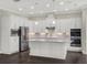 Modern kitchen with white cabinets and stainless steel appliances at 8758 Pinter St, Orlando, FL 32827