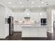 Modern kitchen featuring white cabinetry, granite countertops, and stainless steel appliances at 8758 Pinter St, Orlando, FL 32827