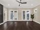 Living room with hardwood floors, and access to outdoor patio with a built-in grill at 8758 Pinter St, Orlando, FL 32827