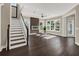 Sunlit living room showcasing hardwood floors, fireplace, and large windows at 8758 Pinter St, Orlando, FL 32827