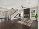 Sunlit living room showcasing hardwood floors, fireplace, and large windows at 8758 Pinter St, Orlando, FL 32827