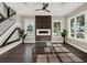 Sunlit living room showcasing hardwood floors, fireplace, and large windows at 8758 Pinter St, Orlando, FL 32827