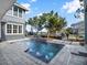 Luxury pool with water features and adjacent patio at 8758 Pinter St, Orlando, FL 32827