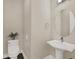 Stylish powder room featuring pedestal sink and circular mirror at 8758 Pinter St, Orlando, FL 32827