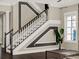 Elegant staircase with dark wood railings and neutral wall accents at 8758 Pinter St, Orlando, FL 32827