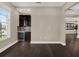 Modern wet bar with dark cabinetry, wine cooler, and mosaic backsplash at 8758 Pinter St, Orlando, FL 32827