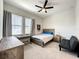 Bright bedroom with wood bed frame, desk, and window seating at 9062 Sperry St, Orlando, FL 32827