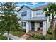 Two-story house with gray siding, metal roof, and a welcoming front porch at 9062 Sperry St, Orlando, FL 32827