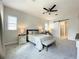 Bright main bedroom features a barn door to the ensuite bathroom and a ceiling fan at 9062 Sperry St, Orlando, FL 32827