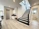 Modern staircase with black and white design, leading to upper level at 9062 Sperry St, Orlando, FL 32827