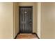 Simple apartment entry with a dark brown door and wood flooring at 911 N Orange Ave # 214, Orlando, FL 32801