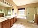 Large bathroom with double vanity, soaking tub, and walk-in shower at 914 Shadowmoss Dr, Winter Garden, FL 34787