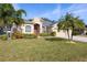 Single-story home with red door, palm trees, and well-manicured lawn at 914 Shadowmoss Dr, Winter Garden, FL 34787