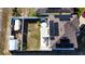 An aerial view of a home with solar panels, a fenced yard, and outdoor living spaces at 376 Willet St, Haines City, FL 33844