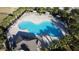 An overhead shot shows a unique community pool area surrounded by lush palm trees at 376 Willet St, Haines City, FL 33844