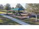 Community playground with slides, climbing structures, benches, and a covered picnic area at 376 Willet St, Haines City, FL 33844