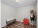 Bright bedroom with wood-look floors, featuring a bench and stylish storage at 110 Oak St, Clermont, FL 34711