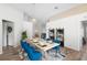 Dining area with wood table, blue chairs, and a modern shelving unit at 110 Oak St, Clermont, FL 34711