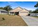 House exterior showcasing a front yard and driveway at 110 Oak St, Clermont, FL 34711