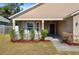 House with covered porch, manicured landscaping and walkway at 110 Oak St, Clermont, FL 34711