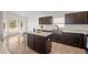 Kitchen with island, copper sink, and dark brown cabinets at 110 Oak St, Clermont, FL 34711