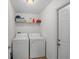 Laundry room with washer, dryer, and overhead shelving at 110 Oak St, Clermont, FL 34711