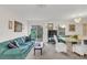 Living room with teal couch and sliding glass doors at 1209 W 6Th St, Sanford, FL 32771