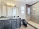 Elegant bathroom with granite vanity, large mirror, and a walk-in shower at 12812 Jacob Grace Ct, Windermere, FL 34786