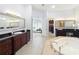 Elegant bathroom with double vanities and a view of the bedroom at 12812 Jacob Grace Ct, Windermere, FL 34786