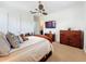 Bedroom featuring a comfy bed, dresser, and TV at 12812 Jacob Grace Ct, Windermere, FL 34786