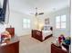 Bedroom with wood furniture, TV, and plush carpeting at 12812 Jacob Grace Ct, Windermere, FL 34786