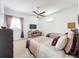 Bright bedroom with two twin beds, a sitting area, and large window at 12812 Jacob Grace Ct, Windermere, FL 34786