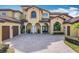 Front view of house with two-car garage and paver driveway at 12812 Jacob Grace Ct, Windermere, FL 34786